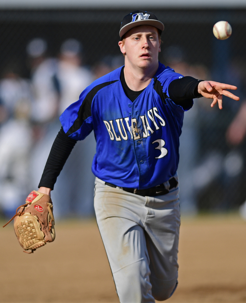 McDONALD, OHIO - APRIL 12, 2017: Jackson Milton starting pitcher Sebastian Lay (3) flips it to first basemen Zach Socha, not pictured, of Wednesday evenings game at Woodland Park. Jackson-Milton won 3-2. DAVID DERMER | THE VINDICATOR