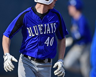 McDONALD, OHIO - APRIL 12, 2017: Jackson-Milton's Joey Willams (40) watches as his ball rolls around in left field for a two RBI single in the third inning of Wednesday evenings game at Woodland Park. Jackson-Milton won 3-2. DAVID DERMER | THE VINDICATOR