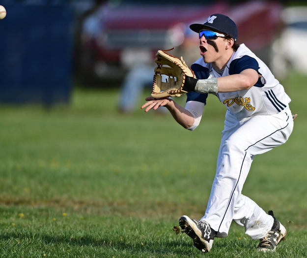McDONALD, OHIO - APRIL 12, 2017: McDonald's Nick Shiley gets under the fly ball for the out in the fourth inning of Wednesday evenings game at Woodland Park. Jackson-Milton won 3-2. DAVID DERMER | THE VINDICATOR