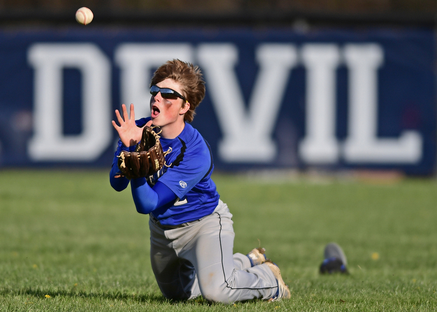 McDONALD, OHIO - APRIL 12, 2017: Jackson-Milton's Scott Mitchell (2) dives to catch the ball for the out in the fourth inning of Wednesday evenings game at Woodland Park. Jackson-Milton won 3-2. DAVID DERMER | THE VINDICATOR
