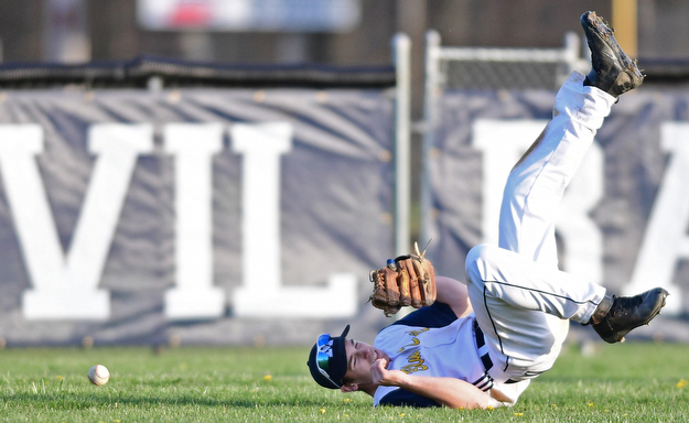 McDONALD, OHIO - APRIL 12, 2017: McDonald's Joey Sudol rolls over on his back after an unsuccessful dive in an attempt to catch the ball in the seventh inning of Wednesday evenings game at Woodland Park. Jackson-Milton won 3-2. DAVID DERMER | THE VINDICATOR