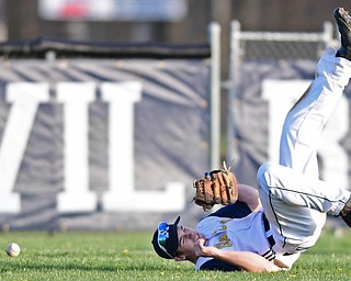 McDONALD, OHIO - APRIL 12, 2017: McDonald's Joey Sudol rolls over on his back after an unsuccessful dive in an attempt to catch the ball in the seventh inning of Wednesday evenings game at Woodland Park. Jackson-Milton won 3-2. DAVID DERMER | THE VINDICATOR