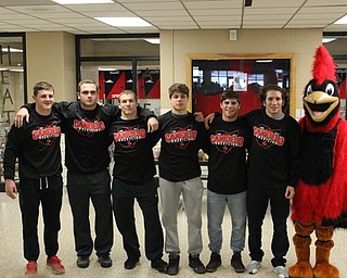 Neighbors | Abby Slanker.Canfield High School wrestling team members, from left, Tyler Stein, Mason Giordano, David Crawford, Anthony D'Alesio, Georgio Poullas and Dominic Cooper prepared to compete at the state wrestling competition after a walk though at the high school on March 8. They were joined by the Canfield Cardinals mascot, Big Red.