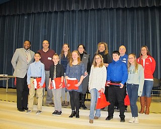 Neighbors | Alexis Bartolomucci.The essay contest winners, charity representatives and Austintown Kiwanis Club President took a picture together after the students read their essays out loud on March 15 at Austintown Middle School.