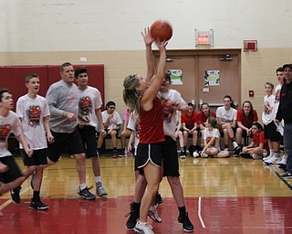 Neighbors | Abby Slanker.A Canfield Village Middle School staff member takes a shot during the school’s annual Students Versus Staff Basketball Game on March 10.