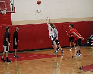 Neighbors | Abby Slanker.A member of the Canfield Village Middle School girls basketball team launches a shot as members of the CVMS staff look on during the school’s annual Students Versus Staff Basketball Game.