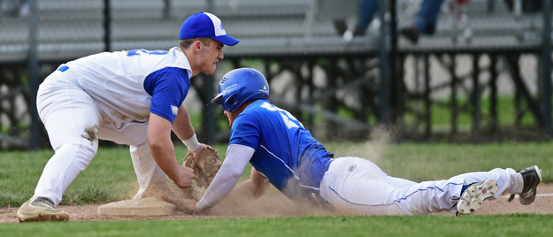 HUBBARD, OHIO - APRIL 13, 2017: Hubbard's Kent Kroynovich, left, tags out Poland's Padraig O'Shaughnessy, right, at third base after a throw from right fielder Lukas Mosora, not pictured, in the fourth inning of Thursday evenings game at Hubbard High School. DAVID DERMER | THE VINDICATOR