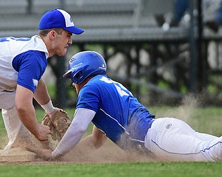 HUBBARD, OHIO - APRIL 13, 2017: Hubbard's Kent Kroynovich, left, tags out Poland's Padraig O'Shaughnessy, right, at third base after a throw from right fielder Lukas Mosora, not pictured, in the fourth inning of Thursday evenings game at Hubbard High School. DAVID DERMER | THE VINDICATOR