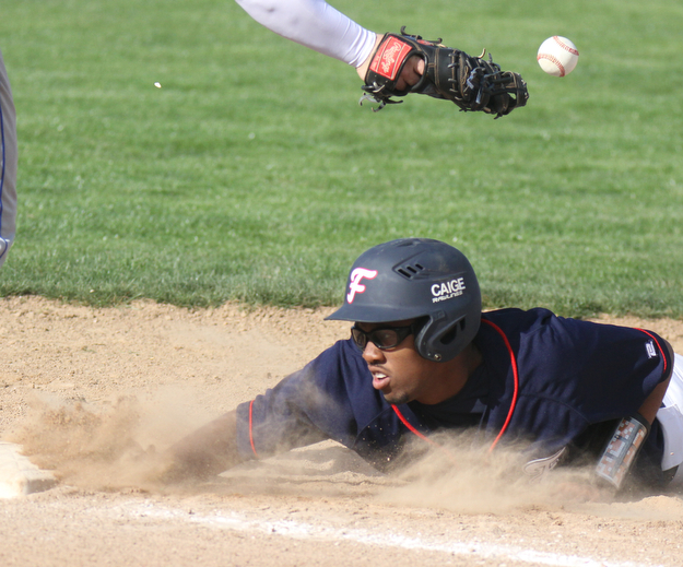 William D Lewis The Vindicator Fitch's Malik Caige(19) dives back to first as Poland's Padraig O'Shaughnessey(21) looses the ball during a pick off attempt in a 4-171-7 game at Fitcgh.