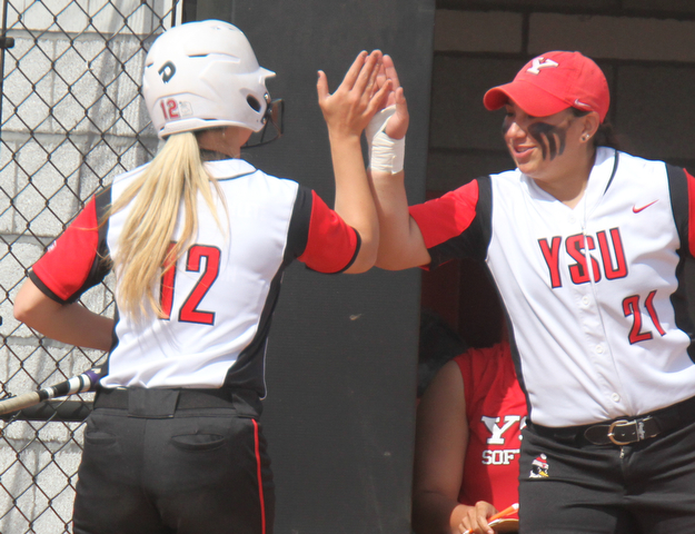 William d. Lewis The Vindicator YSU's Tatum Christy(12) gets congrats from Alexandria Gibson(21) after scoring during 4-18-17 game at YSU.
