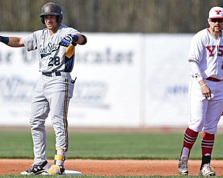 NILES, OHIO - APRIL 18, 2017: Kent State's Dylan Rosa, left, celebrates a two RBI double in front of Youngstown State's Tanner Montgomery in the first inning of their game Tuesday evening game at Eastwood Field. Kent State won 6-3. DAVID DERMER | THE VINDICATOR