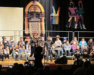 Neighbors | Alexis Bartolomucci.Dobbins students came to the front of the stage to talk about the decade and song they were going to perform next during their concert on March 14.