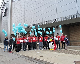 Neighbors | Alexis Bartolomucci.Youngstown State University student-athletes and members from Mahoning County Meals on Wheels prepared to launch their balloons outside the WATTS Center on March 20.