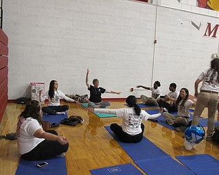 Neighbors | Alexis Bartolomucci.Cardinal Mooney students practiced yoga with an instructor from the YMCA during Yes Fest on March 22.
