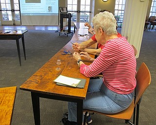 Neighbors | Alexis Bartolomucci.Guests helped each other out making Easter Egg Earrings during the craft program at the Poland library on April 10.