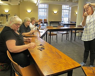 Neighbors | Alexis Bartolomucci.Poland librarian Missy Williams demonstrated how to make the Easter egg earrings during the crafting program at the Poland library on April 10.