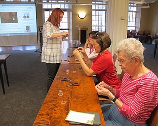 Neighbors | Alexis Bartolomucci.Poland librarian Missy Williams helped out the guests with making their Easter egg earrings during the craft program on April 10 at the Poland library.