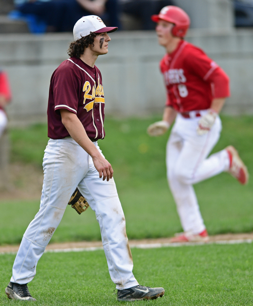 COLUMBIANA, OHIO - APRIL 20, 2017: South Range relief pitcher Ethan Dominguez, left, shows his frustration after a outfielder misplayed the ball allowing Columbiana's Keenan Green to score in the fifth inning of Thursday evenings game at Firestone Park. Columbiana won 4-2. DAVID DERMER | THE VINDICATOR