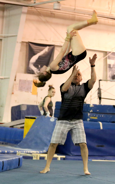 Anna Warhol goes through her floor routine with the help of her coach, Chad Cleland at the Youngstown Gymnastics Center, Thursday, April 20, 2017 in Boardman. Warhol heads to the USA Gymnastics Level 10 National Championship in Indianapolis. ..(Nikos Frazier | The Vindicator)..