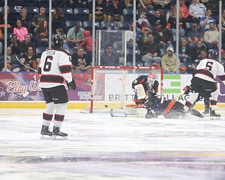 Chicago Steel left wing Eduards Tralmaks (14)(left) looks back after scoring a goal on Youngstown Phantoms goalie Ivan Kulbakov (31) during the 2nd period as the Chicago Steel takes on the Youngstown Phantoms in the USHL Eastern Conference Semifinals, Friday, April 21, 2017 at The Covelli Centre...Also pictured: Youngstown Phantoms forward Chase Gresock (19), Chicago Steel right wing Marc Johnstone (26), Youngstown Phantoms left wing Pierce Crawford (17), and Youngstown Phantoms forward Austin Pooley (12)...(Nikos Frazier | The Vindicator)..