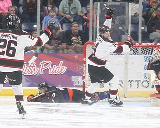 Chicago Steel left wing Eduards Tralmaks (14) celebrates after scoring a goal on Youngstown Phantoms goalie Ivan Kulbakov (31)during the 2nd period as the Chicago Steel takes on the Youngstown Phantoms in the USHL Eastern Conference Semifinals, Friday, April 21, 2017 at The Covelli Centre...Also pictured: Youngstown Phantoms forward Chase Gresock (19), Chicago Steel right wing Marc Johnstone (26), Youngstown Phantoms left wing Pierce Crawford (17), and Youngstown Phantoms forward Austin Pooley (12)...(Nikos Frazier | The Vindicator)..