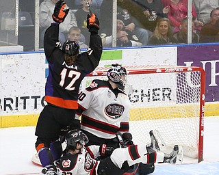 Youngstown Phantoms forward Austin Pooley (12) celebrates his goal against Chicago Steel goalie Ales Stezka (30) as Chicago Steel center Jake Jaremko (23) looks back at the puck during the 1st period as the Chicago Steel takes on the Youngstown Phantoms in Game 4 of the USHL Eastern Conference Semifinals, Saturday, April 22, 2017 at The Covelli Centre in Youngstown...(Nikos Frazier | The Vindicator)..