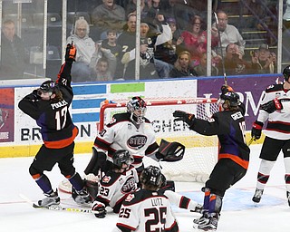 Youngstown Phantoms forward Austin Pooley (12) celebrates his goal against Chicago Steel goalie Ales Stezka (30) as Chicago Steel center Jake Jaremko (23) looks back at the puck during the 1st period as the Chicago Steel takes on the Youngstown Phantoms in Game 4 of the USHL Eastern Conference Semifinals, Saturday, April 22, 2017 at The Covelli Centre in Youngstown...Chicago Steel left wing Reggie Lutz (25), Chicago Steel defenseman Derek Daschke (10) and .(Nikos Frazier | The Vindicator)..