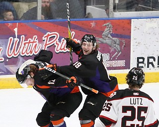 Youngstown Phantoms forward Austin Pooley (12) celebrates his goal against Chicago Steel goalie Ales Stezka (30) with Youngstown Phantoms forward Chase Gresock (19) as Chicago Steel left wing Reggie Lutz (25) looks on during the 1st period as the Chicago Steel takes on the Youngstown Phantoms in Game 4 of the USHL Eastern Conference Semifinals, Saturday, April 22, 2017 at The Covelli Centre in Youngstown...(Nikos Frazier | The Vindicator)..