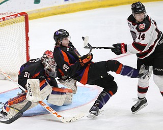 Youngstown Phantoms center Curtis HallÊ (20) falls backwards into Youngstown Phantoms goalie Ivan Kulbakov (31) after being pushed by Chicago Steel left wing Eduards Tralmaks (14) during the 3rd period as the Chicago Steel takes on the Youngstown Phantoms in Game 4 of the USHL Eastern Conference Semifinals, Saturday, April 22, 2017 at The Covelli Centre in Youngstown. The Phantoms won 3-2...(Nikos Frazier | The Vindicator)..
