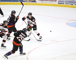 Youngstown Phantoms center Evan Wisocky (25) shoots into the goal against Chicago Steel goalie Ales Stezka (30) for a goal during the 3rd period as the Chicago Steel takes on the Youngstown Phantoms in Game 4 of the USHL Eastern Conference Semifinals, Saturday, April 22, 2017 at The Covelli Centre in Youngstown. The Phantoms won 3-2...Also pictured: Youngstown Phantoms right wing Alex Esposito (23), Chicago Steel defenseman Corson Green (6) and Chicago Steel defenseman Ben Mirageas (12)...(Nikos Frazier | The Vindicator)..