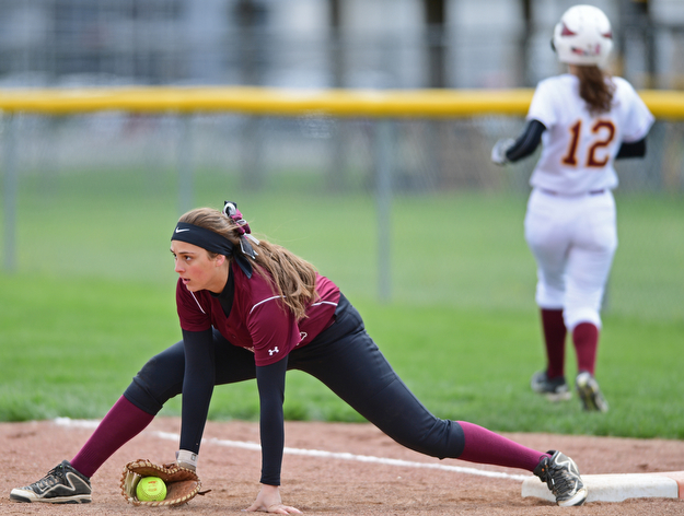 BOARDMAN, OHIO - APRIL 22, 2017: Boardman's Lauren Gabriele, front, steadies herself on the ground after stretching in an unsuccessful attempt to force out Mooney's batter, allowing a run to score in the third inning of Saturday mornings game at Boardman High School. DAVID DERMER | THE VINDICATOR