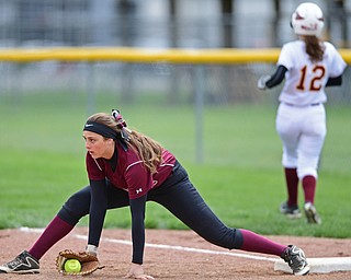 BOARDMAN, OHIO - APRIL 22, 2017: Boardman's Lauren Gabriele, front, steadies herself on the ground after stretching in an unsuccessful attempt to force out Mooney's batter, allowing a run to score in the third inning of Saturday mornings game at Boardman High School. DAVID DERMER | THE VINDICATOR