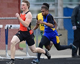 AUSTINTOWN, OHIO - APRIL 22, 2017: Springfield's Ethan Nezbeth sprints ahead of Valley Christian's Kenneth Donaldson and Ursuline's Guy-Michel Kaho during their heat of the boys 200 meter dash, Saturday afternoon during the Mahoning Country Track Meet at Austintown Fitch High School. DAVID DERMER | THE VINDICATOR