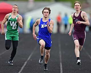 AUSTINTOWN, OHIO - APRIL 22, 2017: Poland's Colin Roarty sprints to the finish line ahead of West Branches Brett Butcher and Boardman's Billy Cammack during their heat of the boys 200 meter dash, Saturday afternoon during the Mahoning Country Track Meet at Austintown Fitch High School. DAVID DERMER | THE VINDICATOR