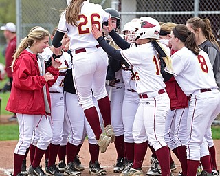 BOARDMAN, OHIO - APRIL 22, 2017: Mooney's Conchetta Rinaldi jumps on home plate while being treated by her teammates after hitting a grand slam in the third inning of Saturday mornings game at Boardman High School. DAVID DERMER | THE VINDICATOR