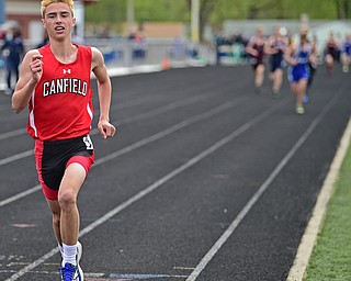 AUSTINTOWN, OHIO - APRIL 22, 2017: Canfield's Giovanni Copploe sprints to the finish line ahead of the pack to win the boys 3200 meter run, Saturday afternoon during the Mahoning Country Track Meet at Austintown Fitch High School. DAVID DERMER | THE VINDICATOR
