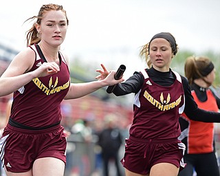 AUSTINTOWN, OHIO - APRIL 22, 2017: South Range's Sarah Spalding receives the baton to teammate Samantha Patrone during the girls 4x100 meter relay, Saturday afternoon during the Mahoning Country Track Meet at Austintown Fitch High School. DAVID DERMER | THE VINDICATOR