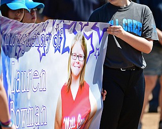 YOUNGSTOWN, OHIO - APRIL 23, 2017: Katie Merdich of Youngstown looks at the banner that was unveiled of her former teammate Lauren Bowman, during the Mill Creek Junior Baseball opening ceremonies, Sunday afternoon at the Mill Creek baseball field complex. DAVID DERMER | THE VINDICATOR