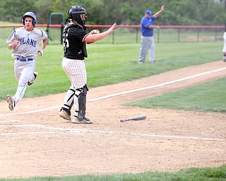 Poland's Braden Olson(22) runs home as Canfield catcher Angelo Petracci(25) signals to the infielders during the 1st inning as Poland High School takes on Canfield High School, Tuesday, March 25, 2017 at Phil Bova Field. Poland won 9-1...(Nikos Frazier | The Vindicator)..