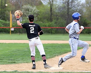 Poland's Vince Garayua(1) crosses first as Canfield first baseman Spencer Woolley(2) waits for the ball during the 4th inning as Poland High School takes on Canfield High School, Tuesday, March 25, 2017 at Phil Bova Field. Poland won 9-1...(Nikos Frazier | The Vindicator)..