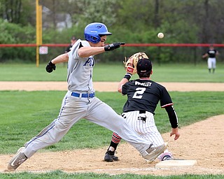 Poland's Don Drummond(2) crosses first as Canfield first baseman Spencer Woolley(2) leans down for the ball during the 4th inning as Poland High School takes on Canfield High School, Tuesday, March 25, 2017 at Phil Bova Field. Poland won 9-1...(Nikos Frazier | The Vindicator)..
