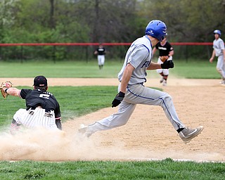 Poland's Don Drummond(2) crosses first as Canfield first baseman Spencer Woolley(2) leans down for the ball during the 4th inning as Poland High School takes on Canfield High School, Tuesday, March 25, 2017 at Phil Bova Field. Poland won 9-1...(Nikos Frazier | The Vindicator)..
