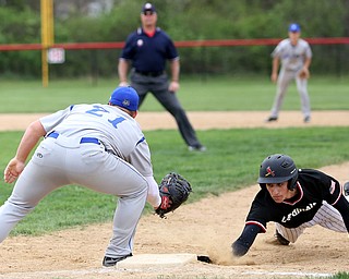 Poland's Mark Wittmann(21) leans down with the ball as Canfield's Jimmy Fitzgerald(32) slides back into first after an attempted steal during the 4th inning as Poland High School takes on Canfield High School, Tuesday, March 25, 2017 at Phil Bova Field. Poland won 9-1...(Nikos Frazier | The Vindicator)..
