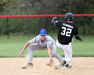 Canfield's Jimmy Fitzgerald(32) jumps over Poland second baseman Braeden O'Shaughnessy(4) during the 4th inning as Poland High School takes on Canfield High School, Tuesday, March 25, 2017 at Phil Bova Field. Poland won 9-1...(Nikos Frazier | The Vindicator)..