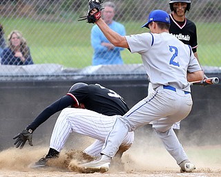 Canfield's Jimmy Fitzgerald(32) slides into home on a steal as Poland's Spencer Woolley(2) tries to tag him out during the 4th inning as Poland High School takes on Canfield High School, Tuesday, March 25, 2017 at Phil Bova Field. Poland won 9-1...(Nikos Frazier | The Vindicator)..