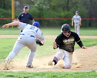 Canfield's Mark Wittmann(21) slides back into first as Poland first baseman Padraig O'Shaughnessy(21) scrambles to grab his missed pass during the 5th inning as Poland High School takes on Canfield High School, Tuesday, March 25, 2017 at Phil Bova Field. Poland won 9-1...(Nikos Frazier | The Vindicator)..