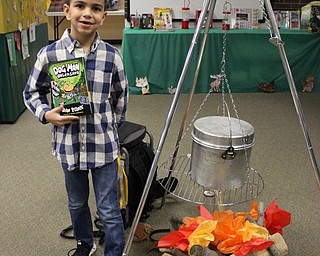 Neighbors | Abby Slanker.After choosing a book, a Hilltop Elementary School first-grade student checked out the ‘campfire’ in the library during the school’s annual book fair with the theme “S’more Fun with Books!” on March 16.