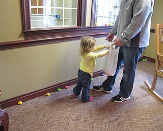 Neighbors | Alexis Bartolomucci.One of the children at the Egg Hunt at the Commons at Greenbriar on April 1 put the eggs she found in her bag.
