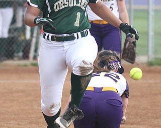William D. Lewis The Vindicator Ursuline's Bethany Rios(1) is safe at 1rst as Cahmpion's Carli Swipas(22) looses the ball during 4-27-17 action .