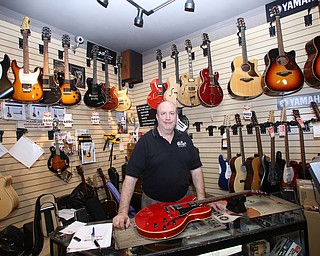 Tom Donadio poses for a photo in the guitar center at Motter's Music, Friday, April 14, 2017 in Canfield. ..(Nikos Frazier | The Vindicator)..